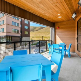 covered patio with blue chairs