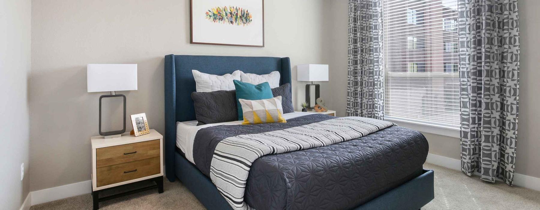 a bedroom with a bed and lamps